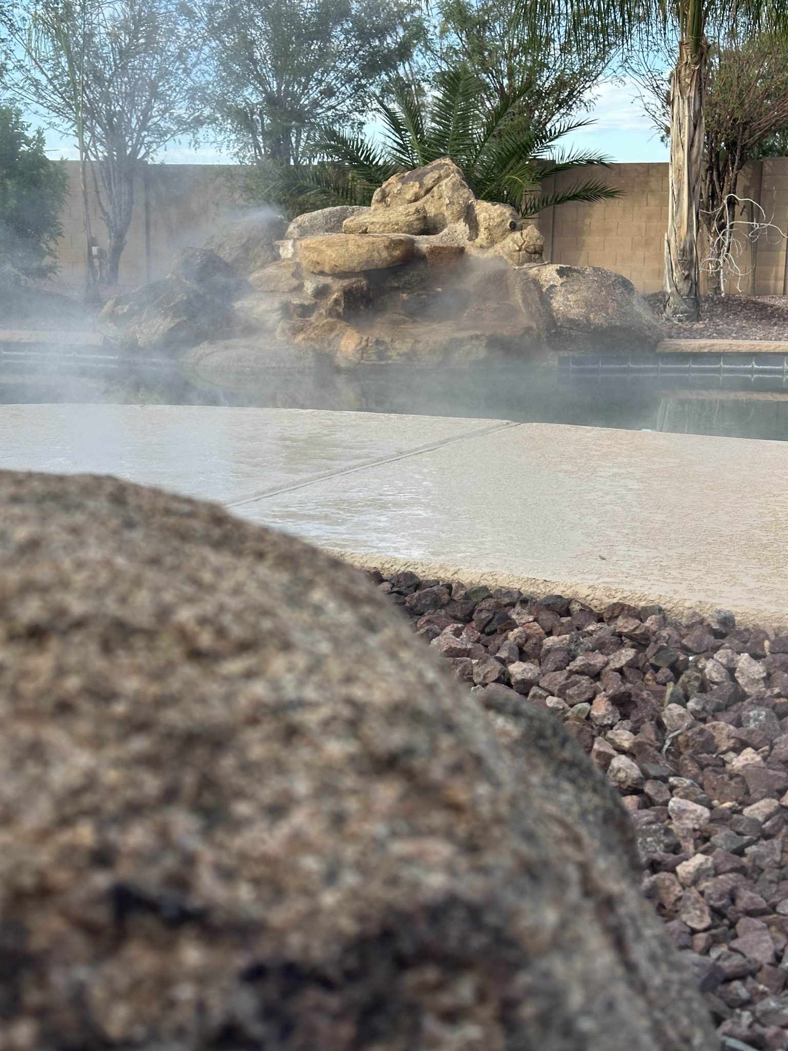 Outdoor misting system providing cooling on a residential patio
